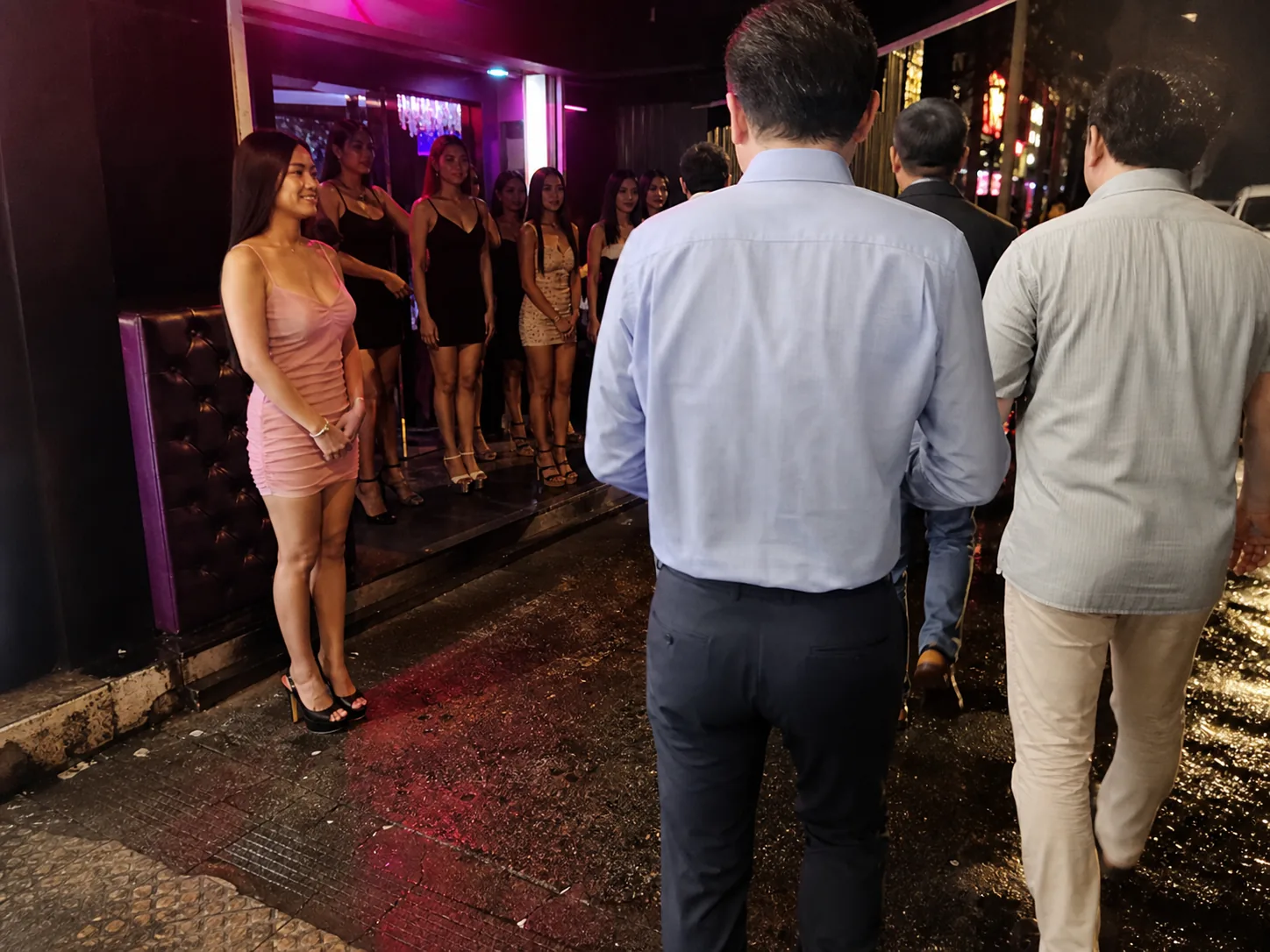 Walking Street JTV entrance with male travelers shown from behind